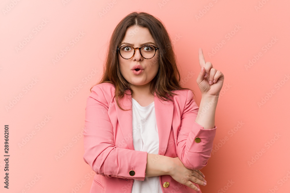 Young plus size business caucasian woman having some great idea, concept of creativity.