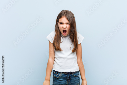 Cute girl screaming very angry and aggressive.