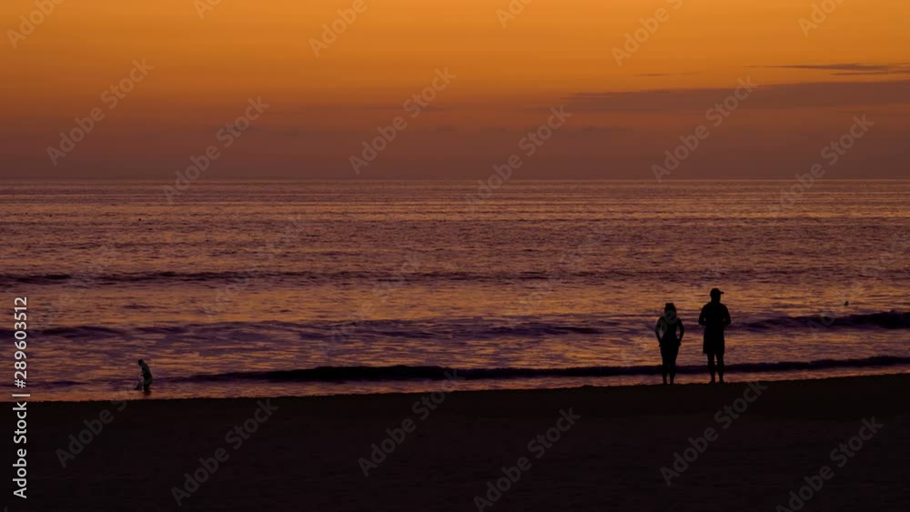Couple Silhouettes at Beach Sunset Couple Silhouettes at Beach Sunset