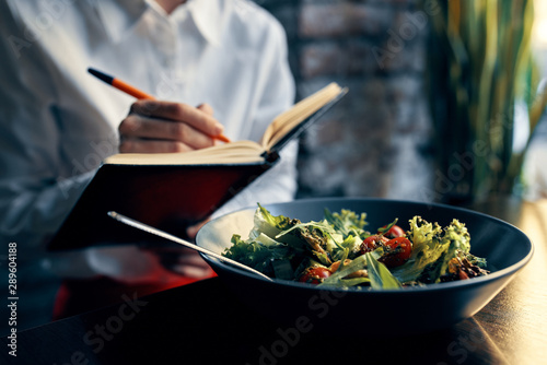 woman eating salad in kitchen