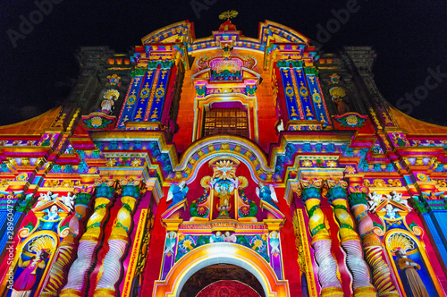 The facade of the Compania de Jesus church illuminated with colorful lights during the light festival, Quito, Ecuador. photo
