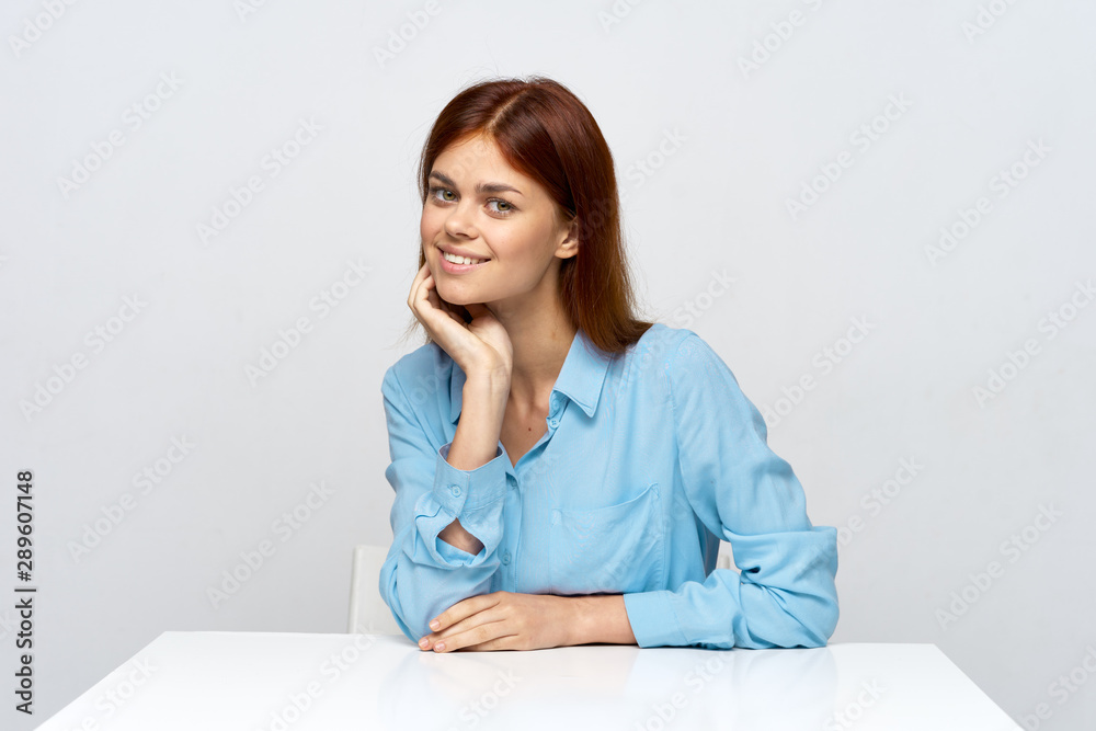 portrait of a young woman sitting at her desk portrait of a young woman sitting at her desk