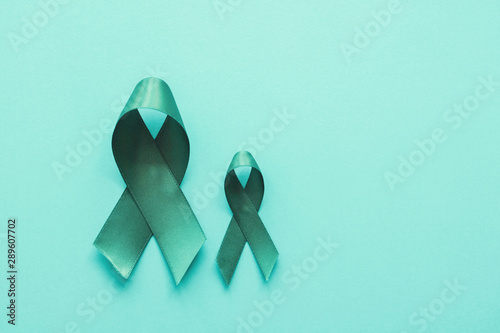 Teal ribbons on blue background, Ovarian Cancer, cervical Cancer, anti bullying and sexual assault awareness