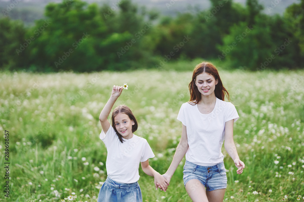 mother and daughter having fun in the park mother and daughter having fun in the park