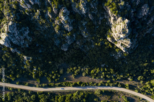 View from above, stunning aerial view of some granite mountains with a road running through them. Sardinia, Italy. photo