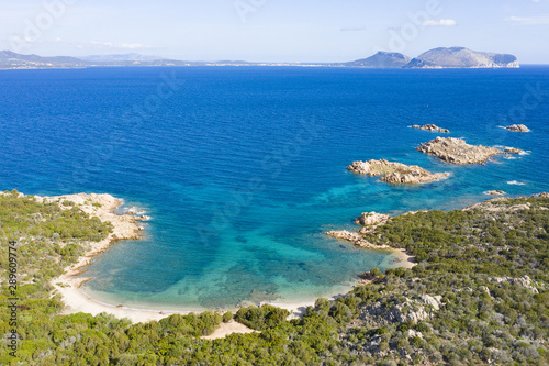 Fototapeta Naklejka Na Ścianę i Meble -  View from above, stunning aerial view of a wild beach bathed by a beautiful turquoise sea. Costa Smeralda (Emerald Coast) Sardinia, Italy.