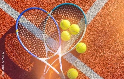 Tennis game. Tennis balls and rackets on  background. © BillionPhotos.com