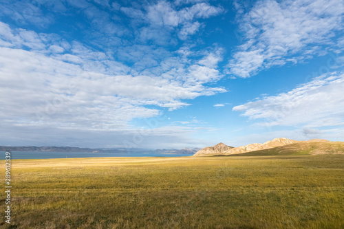 plateau meadow and lake against a blue sky photo