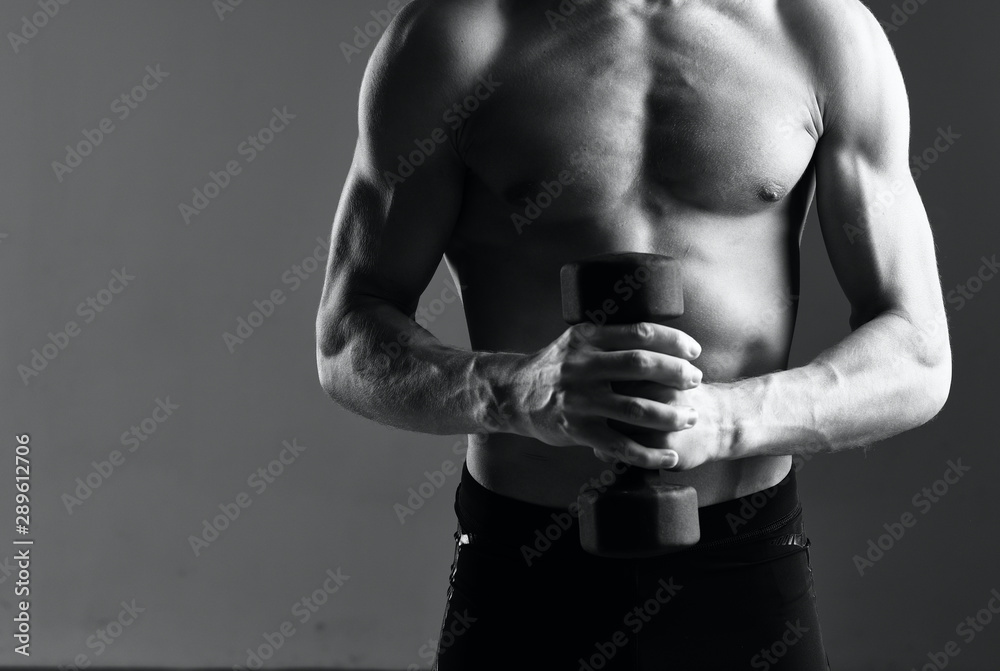 Naklejka premium muscular man with dumbbells