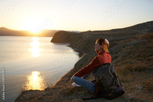 woman meditating on the beach at sunset