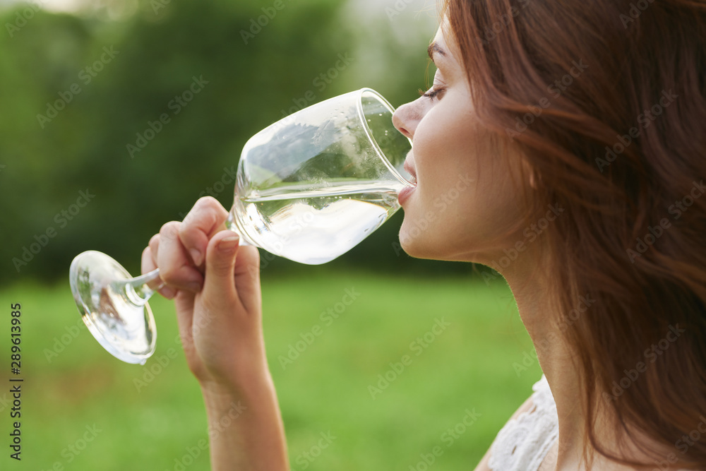 young woman drinking water from a bottle young woman drinking water from a bottle