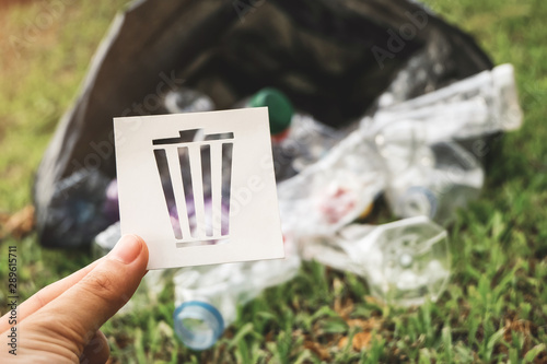 trash icon from paper cut, garbage bags and plastic bottle waste in garden. Environmental pollution and Ecological problem. photo