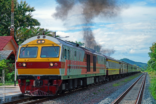 Locomotive Train Speeding up the engine resulting in black smoke after transporting passengers in Railway Station of Thailand. 