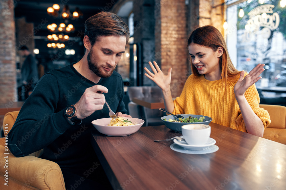 young couple having dinner in a restaurant young couple having dinner in a restaurant