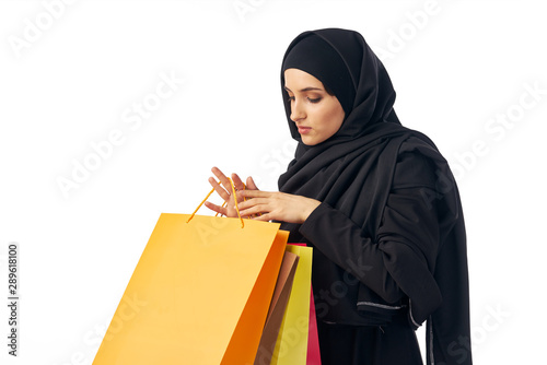 young woman with shopping bags isolated on white