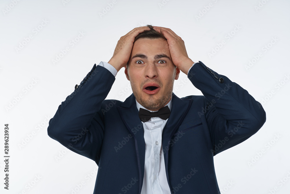 portrait of a man with hands on his head portrait of a man with hands on his head