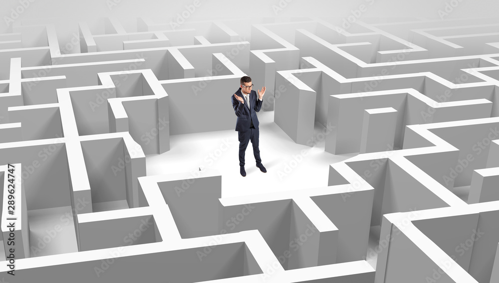 Young businessman standing in a middle of a 3D maze Young businessman standing in a middle of a 3D maze