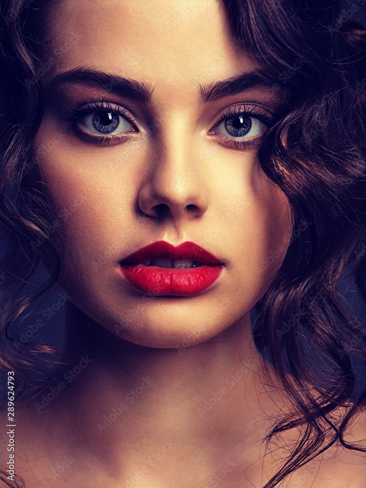 Face of a beautiful woman with a smoky eye makeup and red lipstick Face of a beautiful woman with a smoky eye makeup and red lipstick