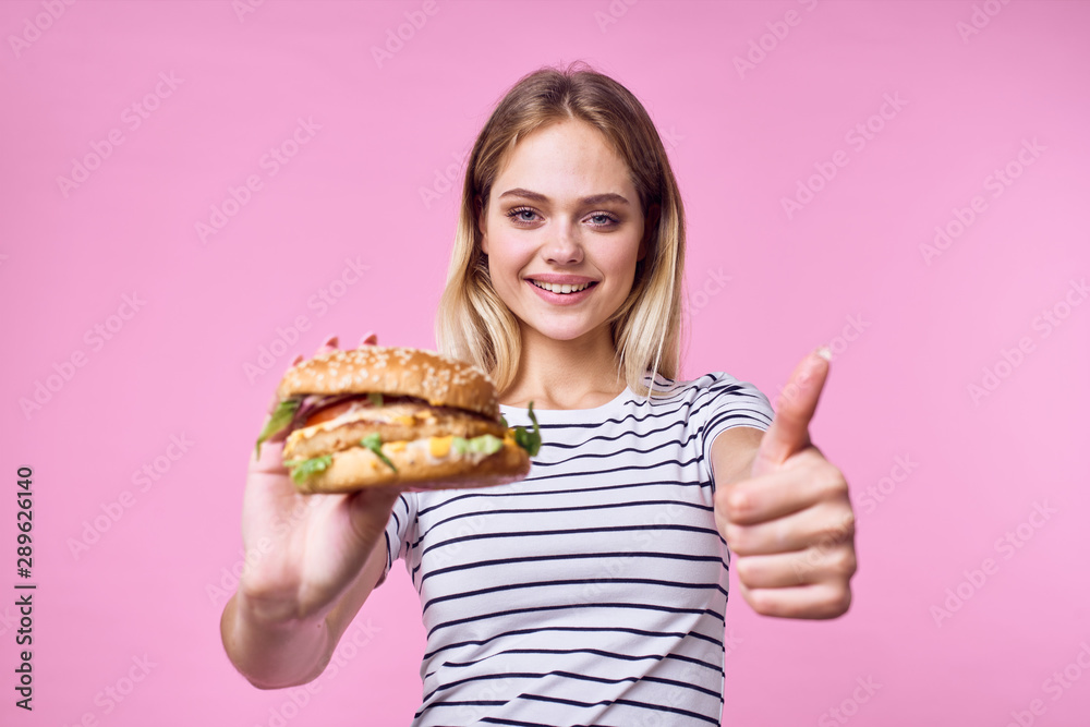 woman with hamburger and french fries woman with hamburger and french fries