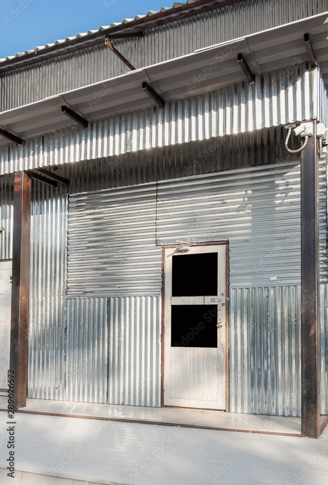 Corrugated galvanized steel surface silver of temporary shelter for construction workers and Industrial factory building. Iron metal sheet vintage style texture for background.