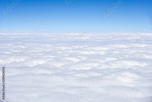 Background of View the blue sky and white clouds from the airplane window with copy space