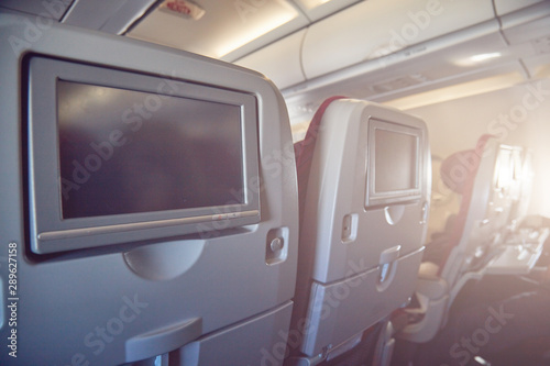 Modern airplane passenger seat with touch - screen. © astrosystem