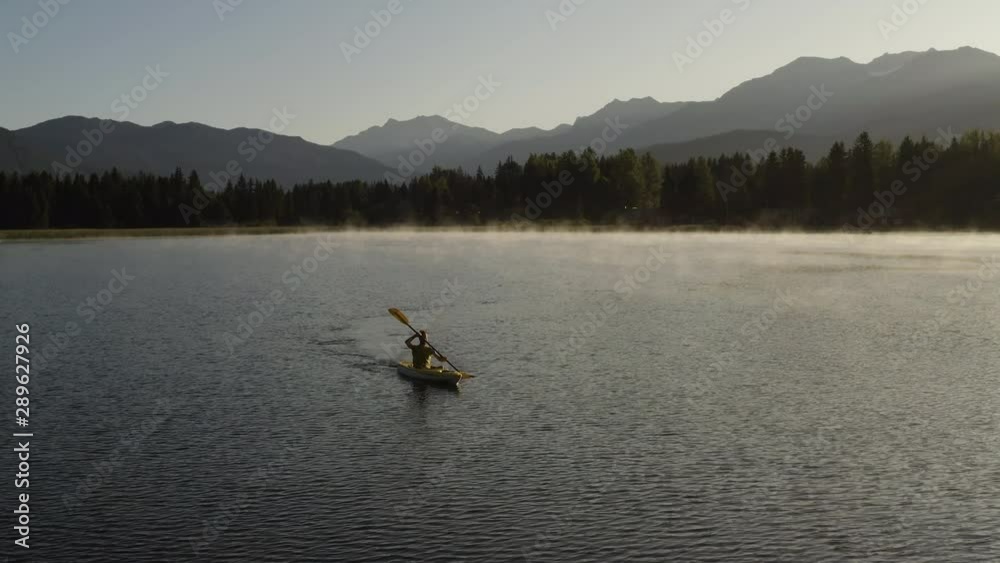 Man Kayaking At Sunrise