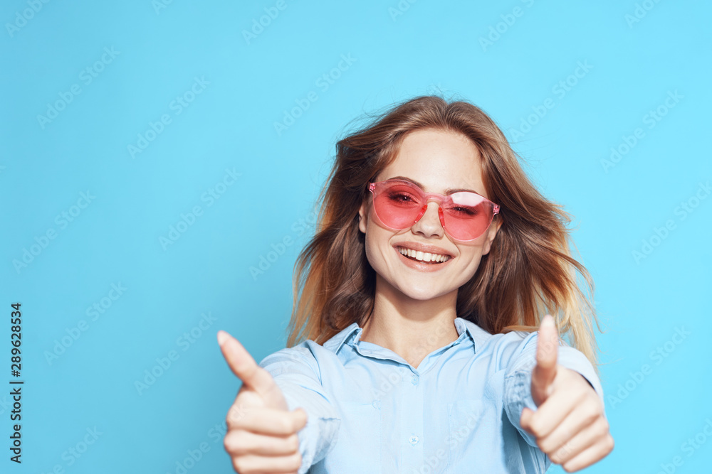 portrait of a young woman showing thumbs up portrait of a young woman showing thumbs up