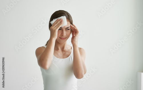 young woman with headache isolated on white