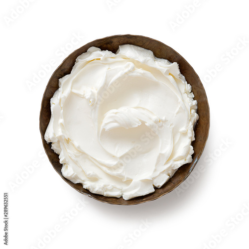Bowl of cream cheese isolated on white background, top view .
