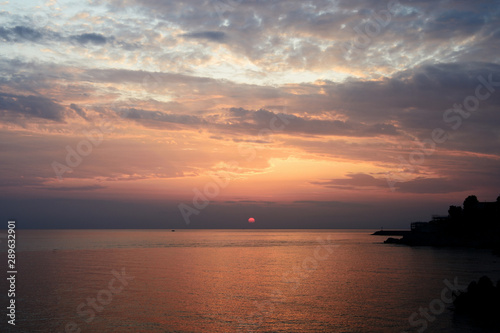 Magnificent sunrise over the sea and beautiful cloudscape on the coast of Sicily. Cefalu, Italy © Talulla