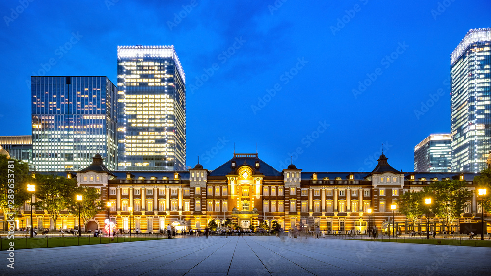 Tokyo railway station and Tokyo modern highrise building at twilight time. Chiyoda city, Tokyo, Japan. Host city of the Olympic Games 2020.