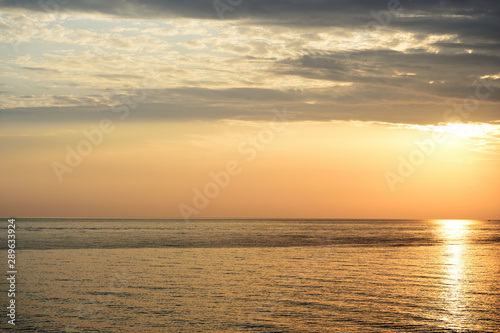 Fototapeta Naklejka Na Ścianę i Meble -  Magnificent sunrise over the sea and beautiful cloudscape on the coast of Sicily. Cefalu, Italy