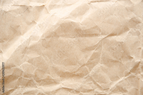 Flat lay craft paper texture. Crumpled cream paper background