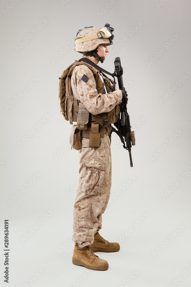 Fototapeta premium Rear view of military soldier US army marines operator studio shot portrait