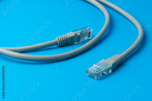 Network cable on a blue background close-up