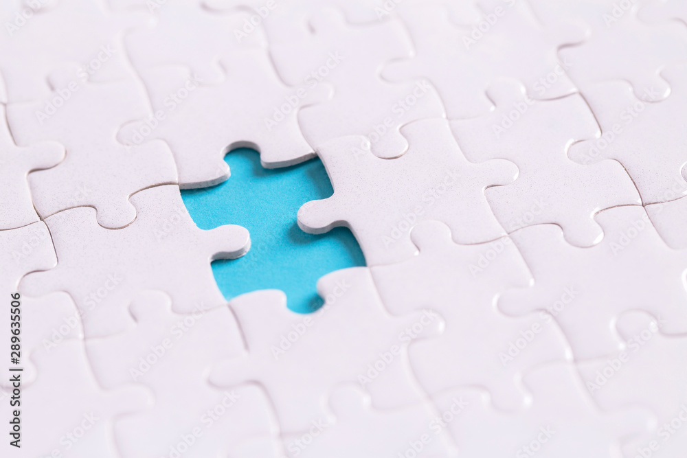 Unfinished jigsaw puzzle on blue background with copy space for your text or content , Working concepts separated from groups Unfinished jigsaw puzzle on blue background with copy space for your text or content , Working concepts separated from groups