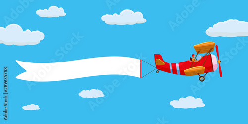 Red retro biplane aircraft pulling advertisement banner