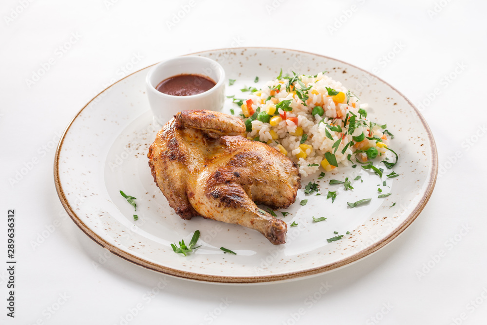 Half chicken tobacco with cooked rice and corn and tomato sauce isolated on white background Half chicken tobacco with cooked rice and corn and tomato sauce isolated on white background