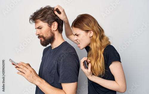 angry woman and man with smartphone
