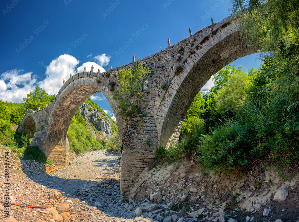 Old Kalogeriko triple arched stone bridge on Vikos canyon, Zagorohoria, Greece