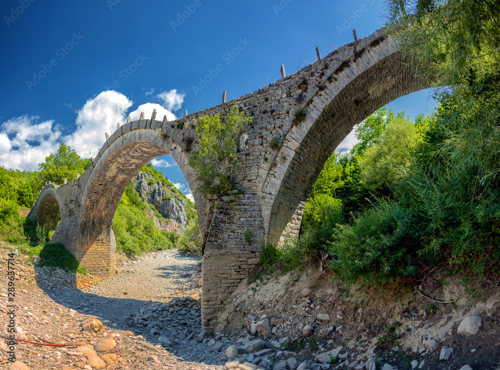 Old Kalogeriko triple arched stone bridge on Vikos canyon, Zagorohoria, Greece Old Kalogeriko triple arched stone bridge on Vikos canyon, Zagorohoria, Greece