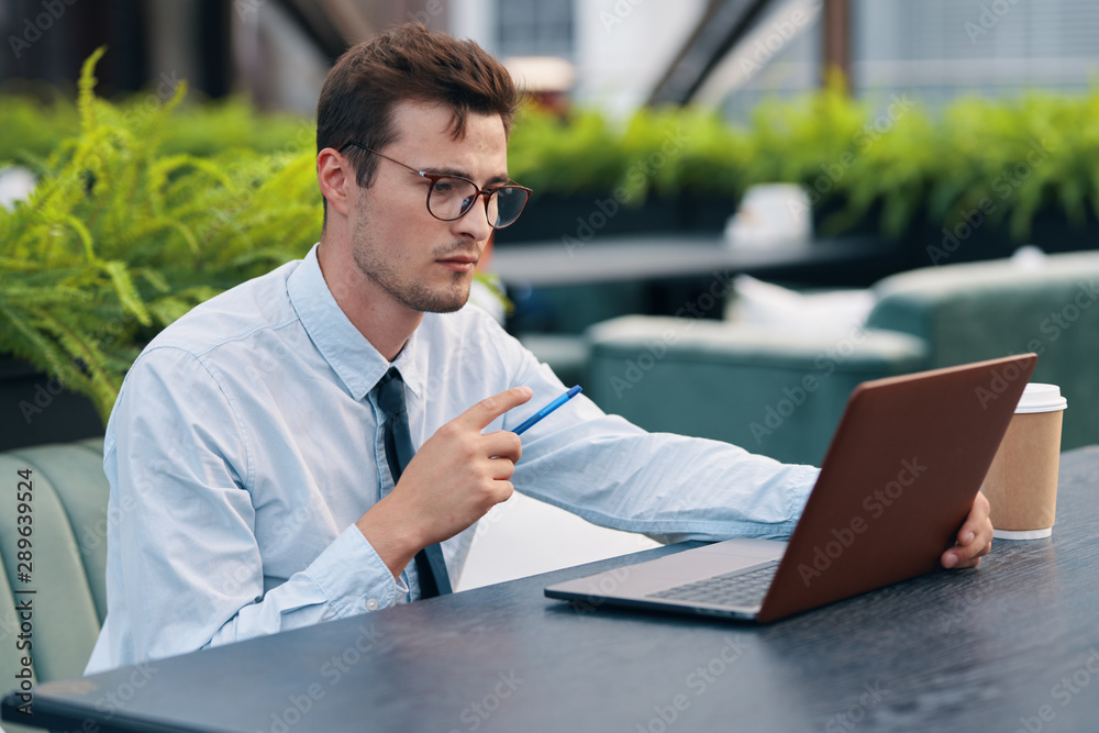 businessman working on his laptop in park