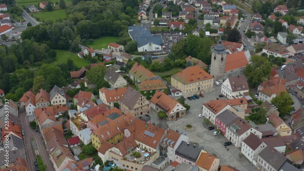 Aerial view of the city Creußen in Germany in Bavaria on a cloudy day in summer. Pan to the left around the front of the city. Aerial view of the city Creußen in Germany in Bavaria on a cloudy day in summer. Pan to the left around the front of the city.