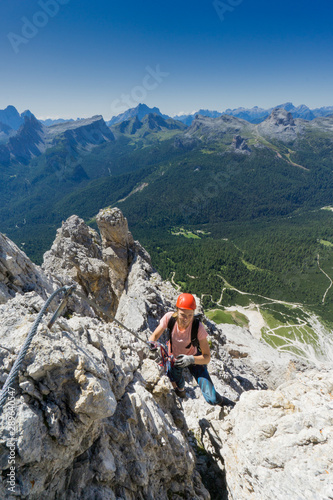 young attractive brunette female mountain climber in the Dolomites of Italy