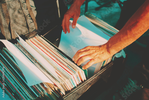 DJ chooses a record from case. Close-up, top view