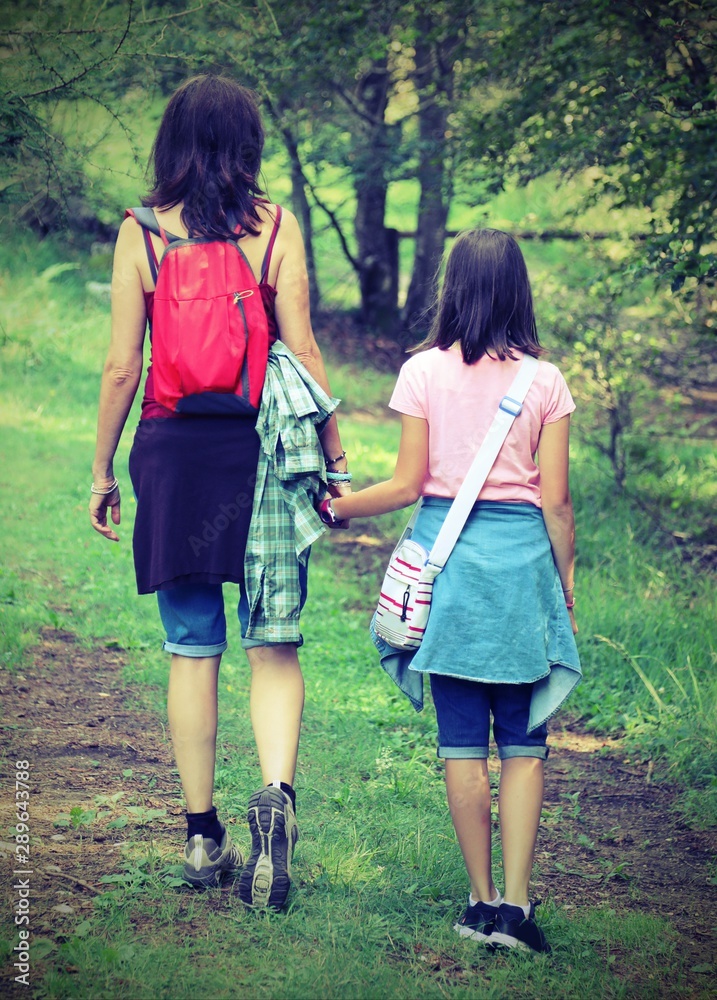 Fototapeta premium Mother and daughter walks in the path with old toned effect