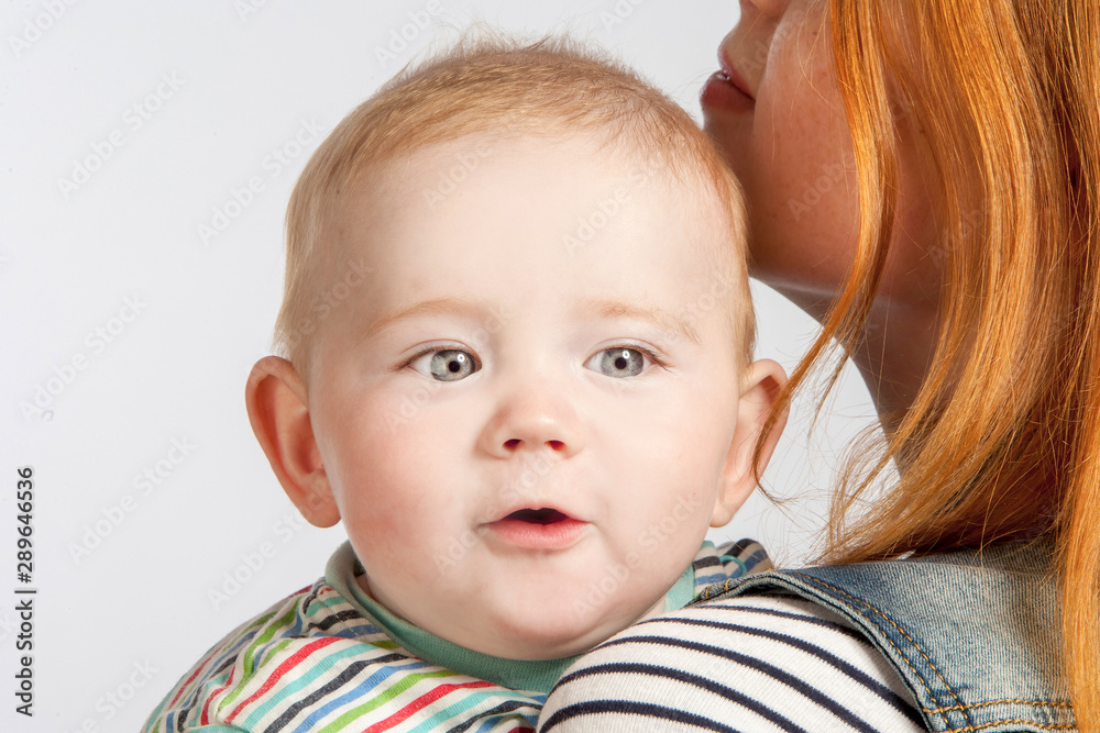 Cute baby in his mother's arms close up. Cute baby in his mother's arms close up.