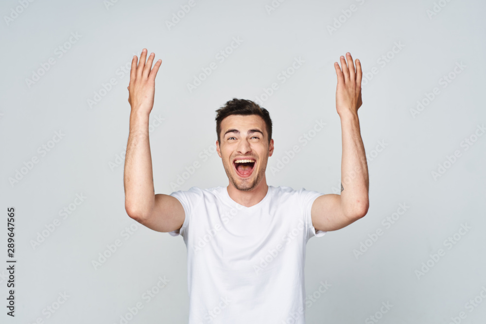 happy young man with arms raised happy young man with arms raised