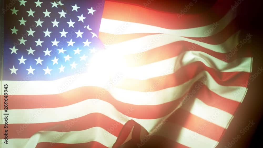 Bright sun shines through waving USA Flag Bright sun shines through waving USA Flag